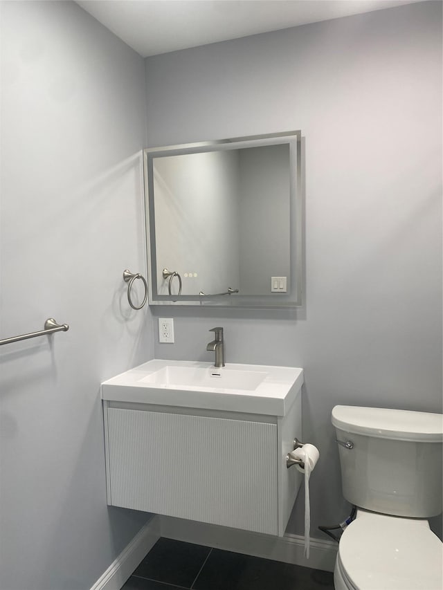 bathroom with tile patterned floors, vanity, and toilet