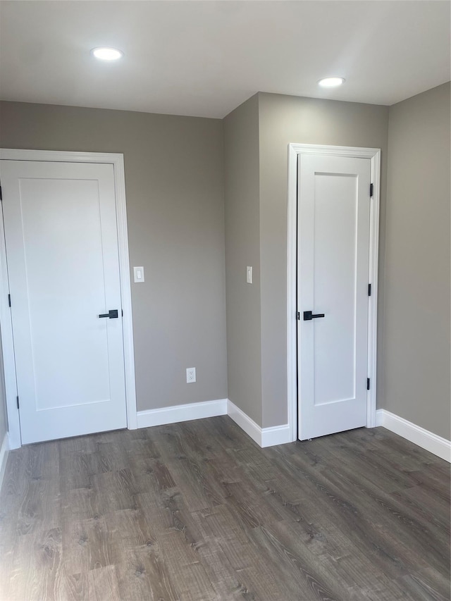 empty room with dark hardwood / wood-style flooring