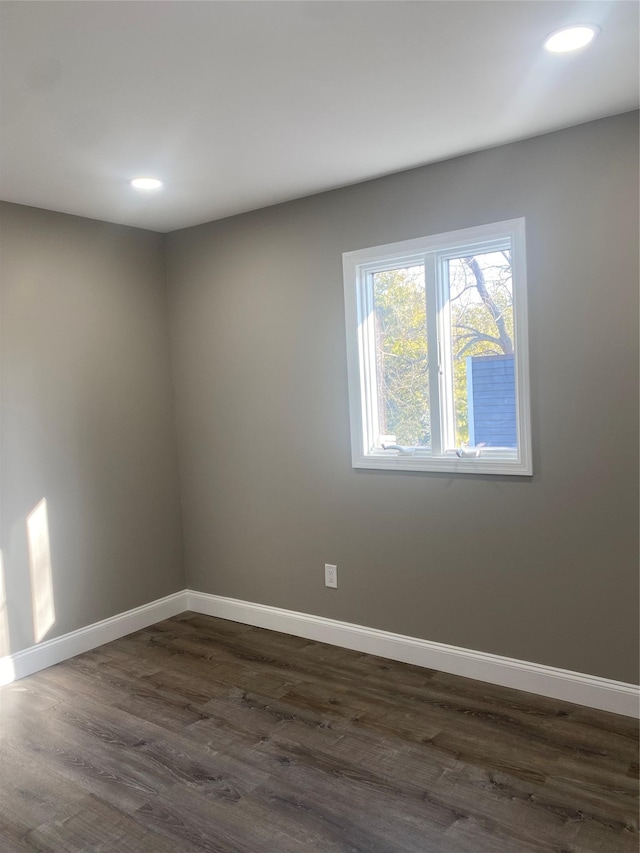 empty room with dark wood-type flooring