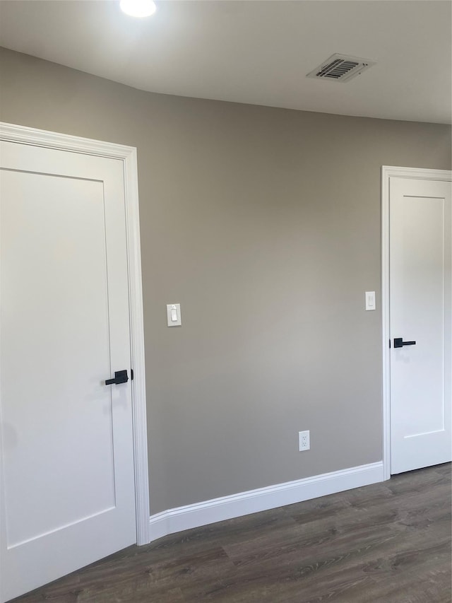 spare room featuring dark hardwood / wood-style flooring