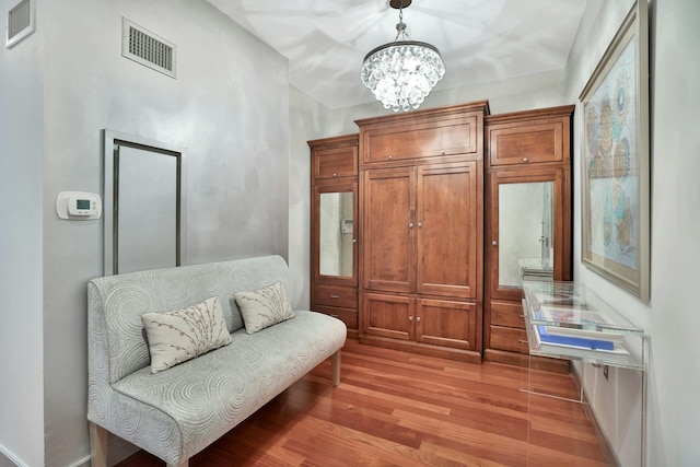 living area featuring a chandelier and light wood-type flooring