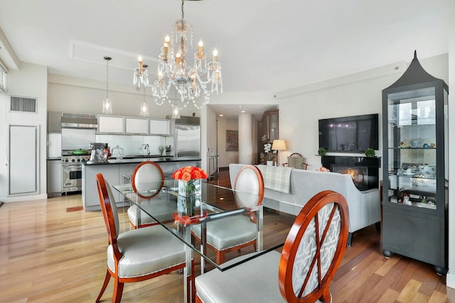 dining area with sink and light hardwood / wood-style flooring