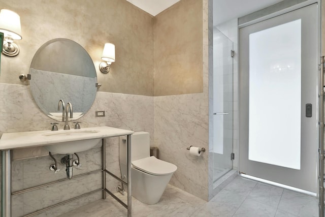 bathroom featuring an enclosed shower, sink, tile walls, and toilet