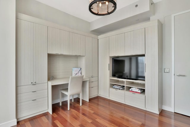 office featuring hardwood / wood-style flooring and built in desk