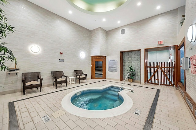 view of pool with an indoor hot tub