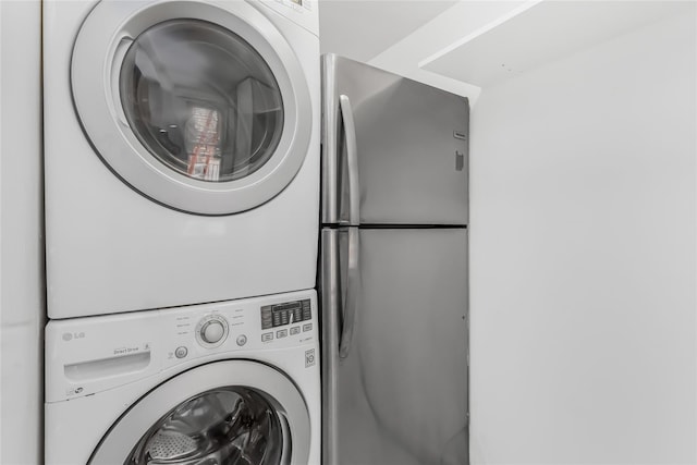 washroom featuring stacked washing maching and dryer