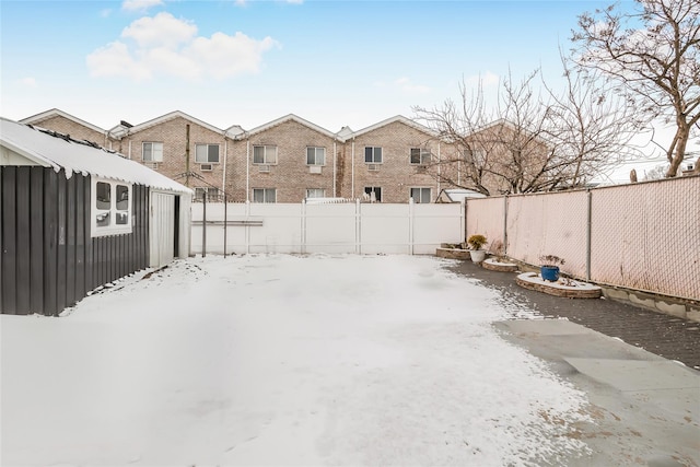 yard layered in snow featuring an outdoor structure