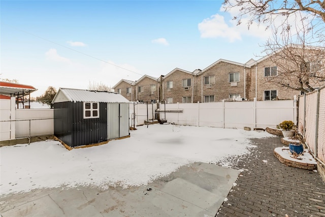 snowy yard with a storage unit