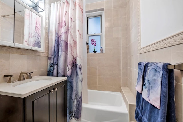 bathroom with tile walls, shower / tub combo, vanity, and backsplash