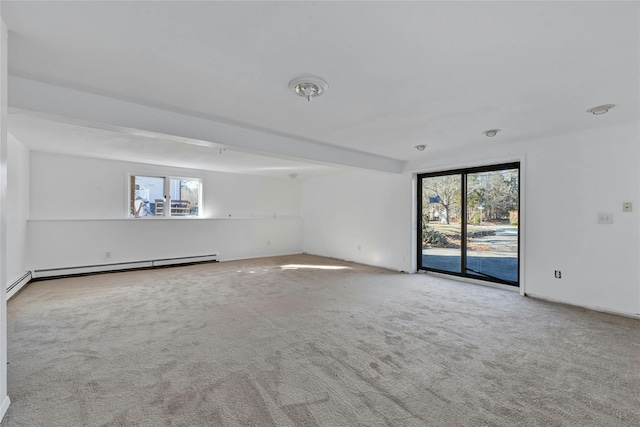 carpeted empty room featuring baseboard heating