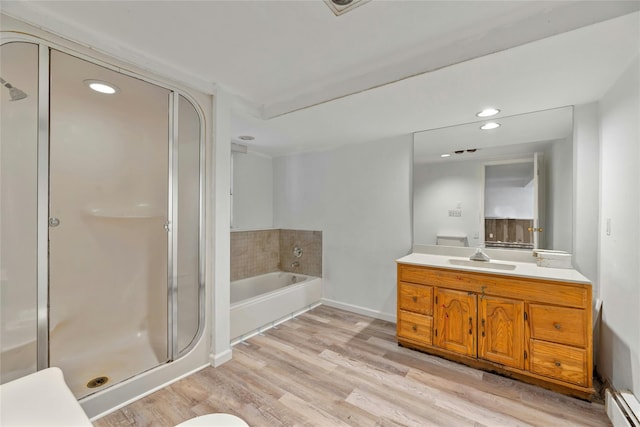 bathroom with independent shower and bath, vanity, wood-type flooring, and baseboard heating