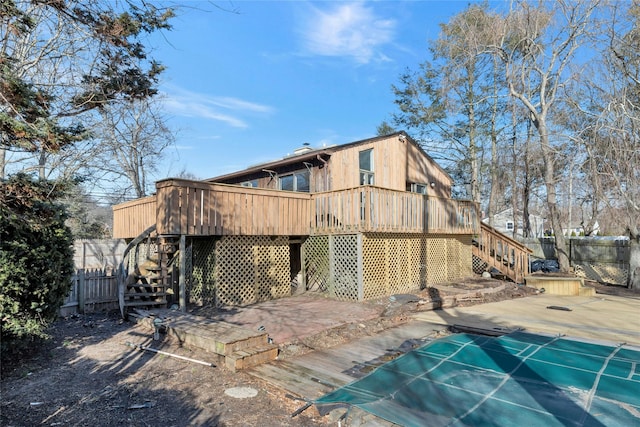 rear view of house with a pool side deck and a patio area