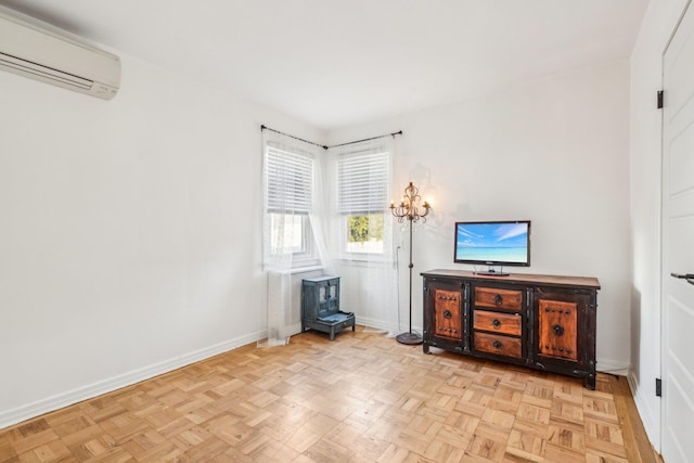 interior space with a wall unit AC and light parquet flooring