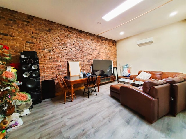 home office featuring brick wall, wood finished floors, and an AC wall unit