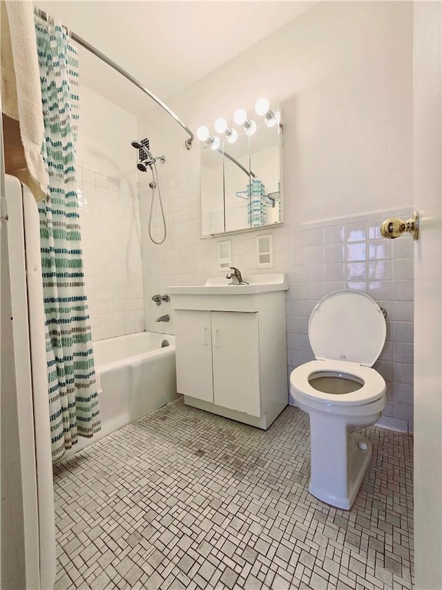 bathroom with vanity, tile patterned flooring, tile walls, and shower / bath combo