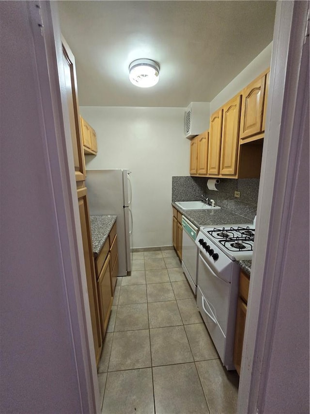 kitchen with sink, backsplash, light tile patterned floors, light brown cabinets, and white appliances