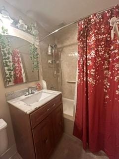 full bathroom with vanity, toilet, and shower / tub combo with curtain