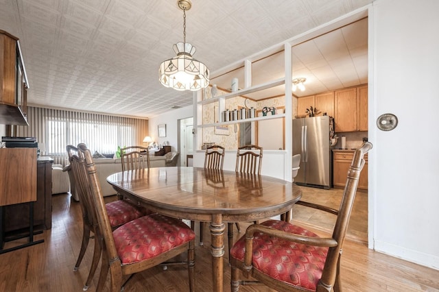 dining space featuring light wood-type flooring