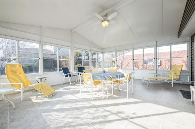 sunroom / solarium with lofted ceiling with beams, a wealth of natural light, and ceiling fan