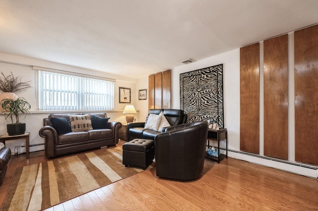 living room with baseboard heating and light wood-type flooring