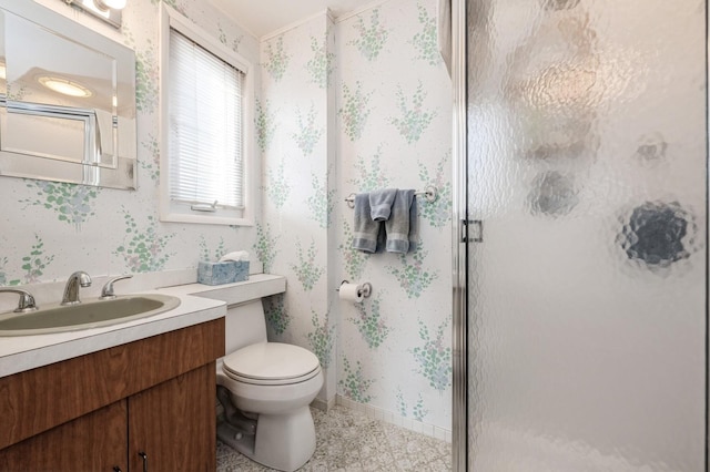 bathroom featuring vanity, an enclosed shower, and toilet