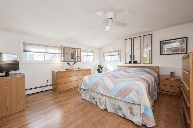 bedroom with ceiling fan, a baseboard radiator, vaulted ceiling, and light hardwood / wood-style flooring