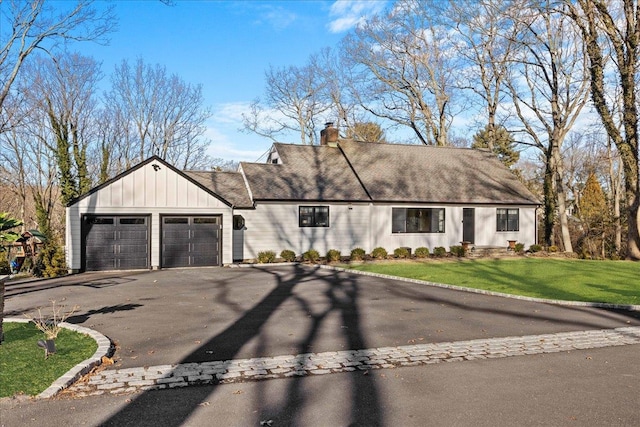 view of front of house with a garage and a front yard