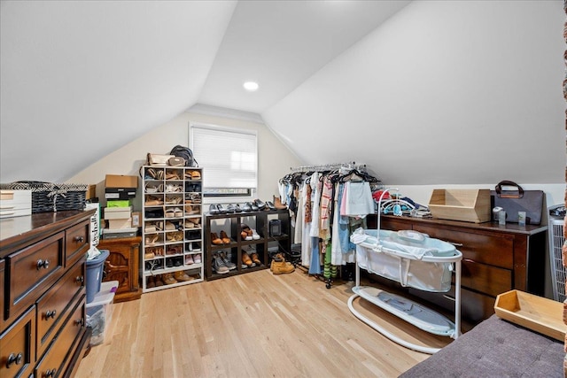 walk in closet featuring vaulted ceiling and light wood-type flooring