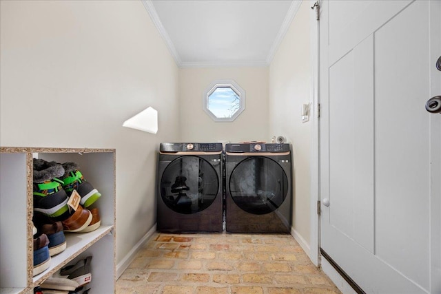 laundry area with crown molding and washing machine and clothes dryer