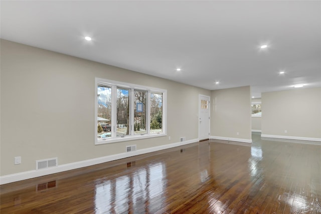 spare room with dark wood-type flooring