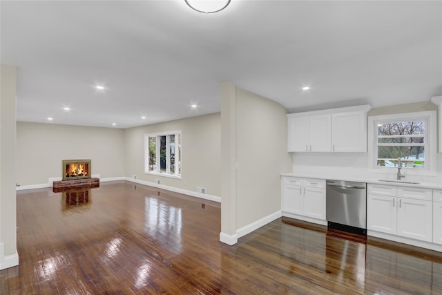 interior space featuring white cabinetry, stainless steel dishwasher, and dark hardwood / wood-style flooring