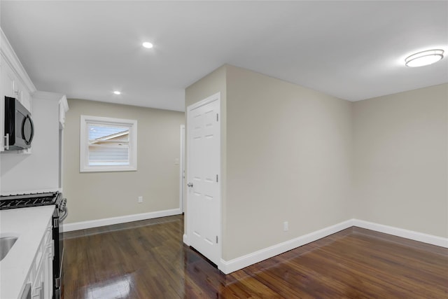 kitchen featuring white cabinets, dark hardwood / wood-style flooring, and stainless steel gas stove