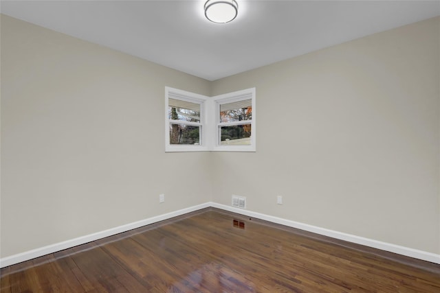 unfurnished room with dark hardwood / wood-style floors