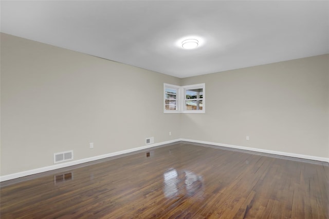 spare room featuring dark hardwood / wood-style flooring