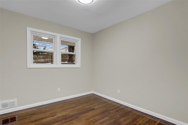 unfurnished room with dark hardwood / wood-style floors