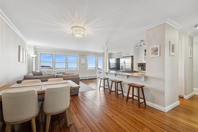 dining area featuring crown molding and dark wood-type flooring