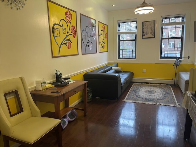 sitting room featuring a baseboard radiator and dark hardwood / wood-style floors