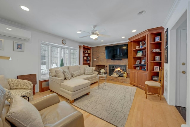 living room with crown molding, a brick fireplace, and a wall unit AC