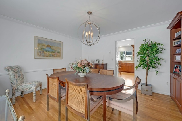 dining room featuring crown molding, an inviting chandelier, and light hardwood / wood-style flooring