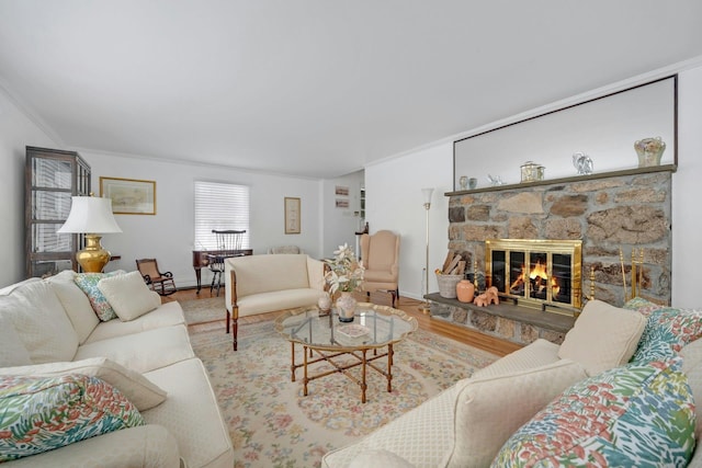 living room with crown molding, a fireplace, and hardwood / wood-style floors