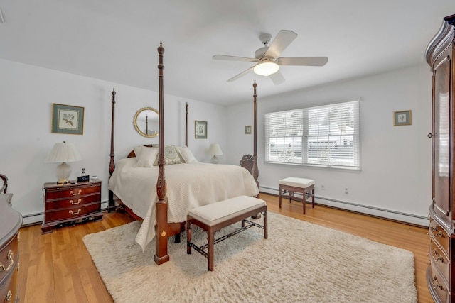 bedroom with ceiling fan, a baseboard radiator, and light hardwood / wood-style floors