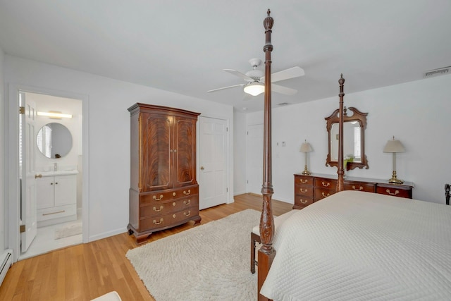 bedroom with baseboard heating, ceiling fan, connected bathroom, and light hardwood / wood-style floors