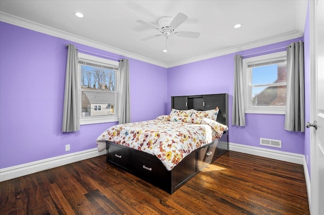 bedroom featuring baseboards, visible vents, dark wood finished floors, and crown molding