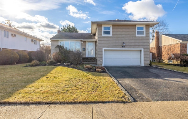 view of front facade with a garage and a front yard