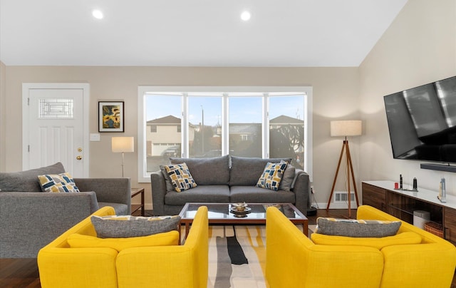 living room featuring hardwood / wood-style floors and vaulted ceiling