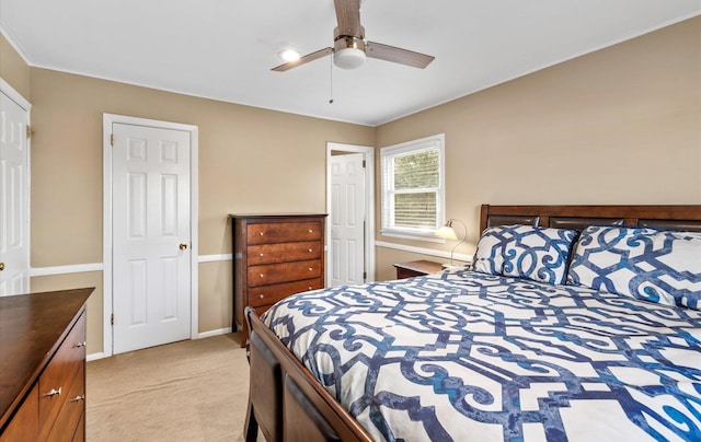 bedroom with ceiling fan and light carpet