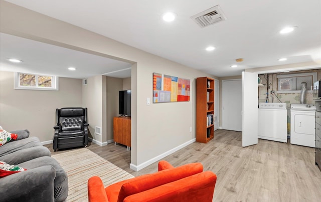 living room featuring light hardwood / wood-style flooring and washer and clothes dryer