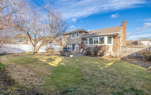 rear view of house with a yard