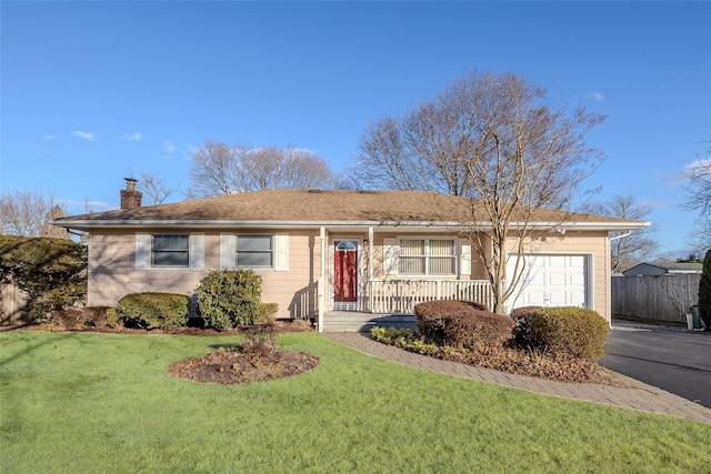 ranch-style home with a garage and a front lawn