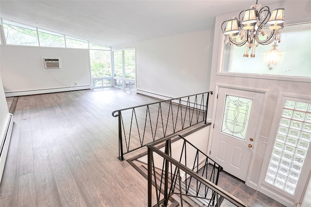 28 Robin Hood Rd, Montebello, NY 10901 - foyer with a baseboard heating unit, a chandelier, lofted ceiling, a wall mounted air conditioner, and healthy amount of natural light
